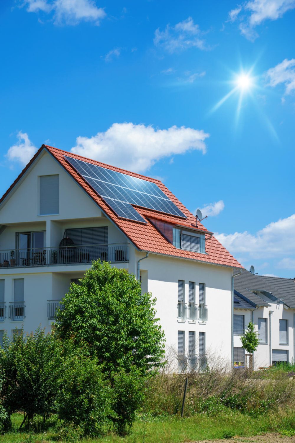 An image of a home with solar energy green plants and sunny blue sky